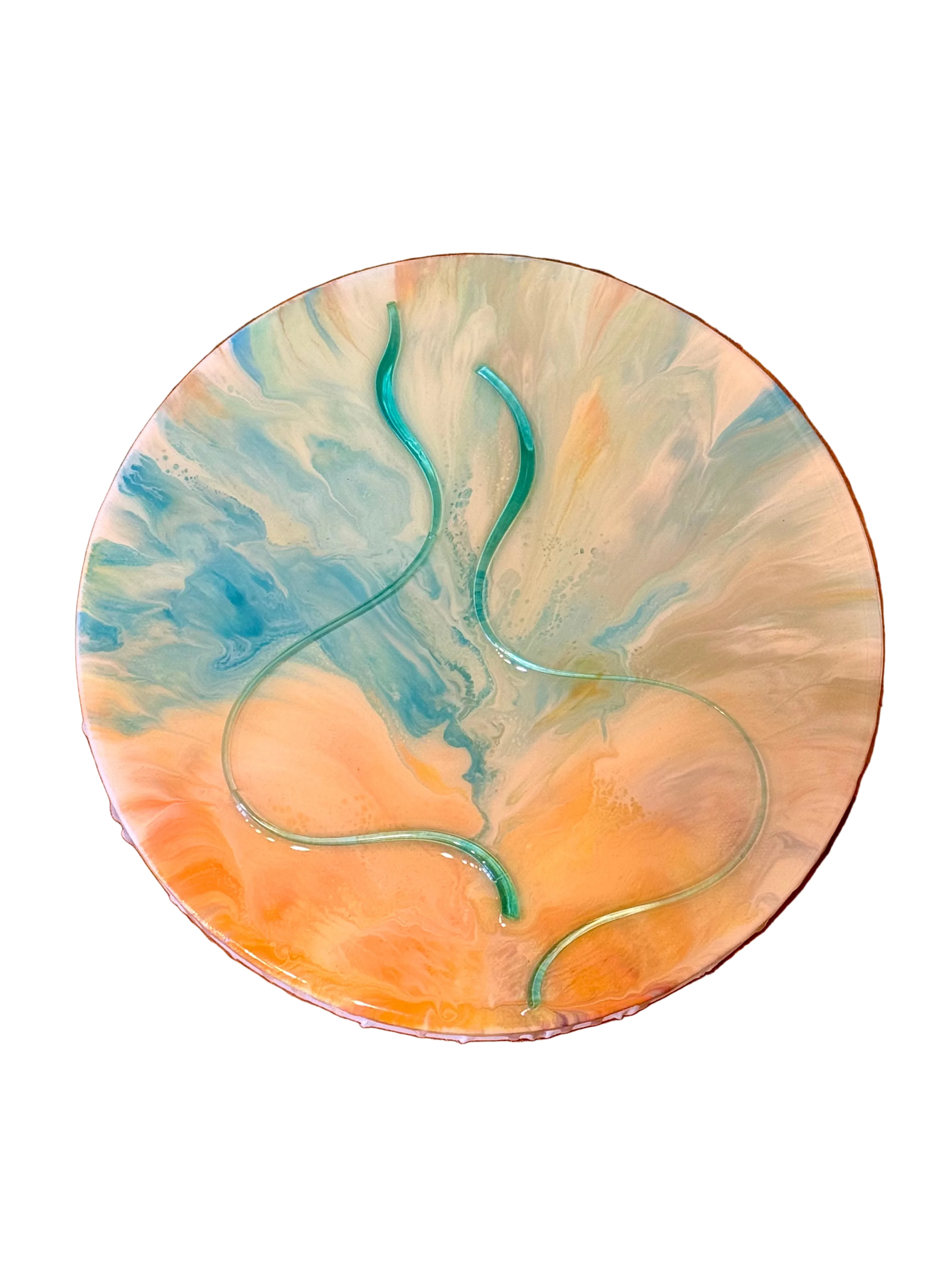 A round abstract art print or coaster featuring a marbled swirl of blue, orange, and cream, with two flowing translucent teal lines, displayed on a wooden surface.