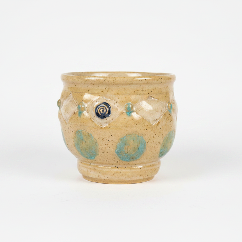 Ceramic cup with decorative patterns on a wooden surface