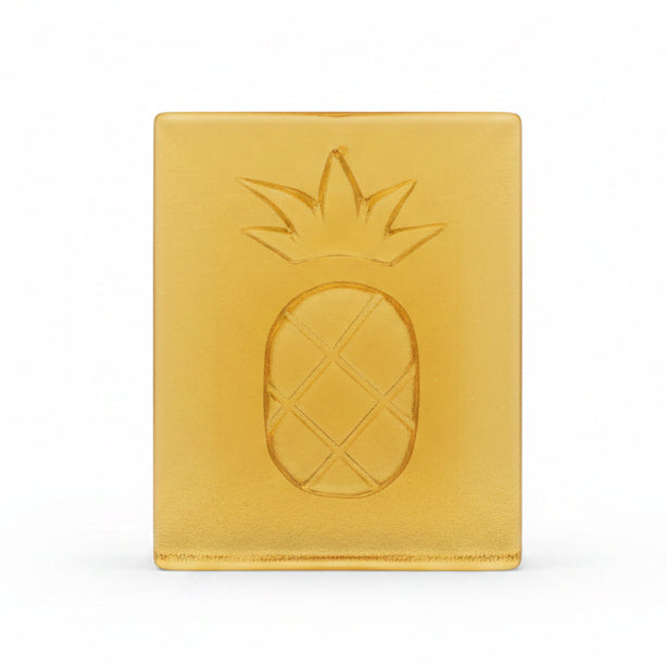 Decorative item with a pineapple design on a wooden surface