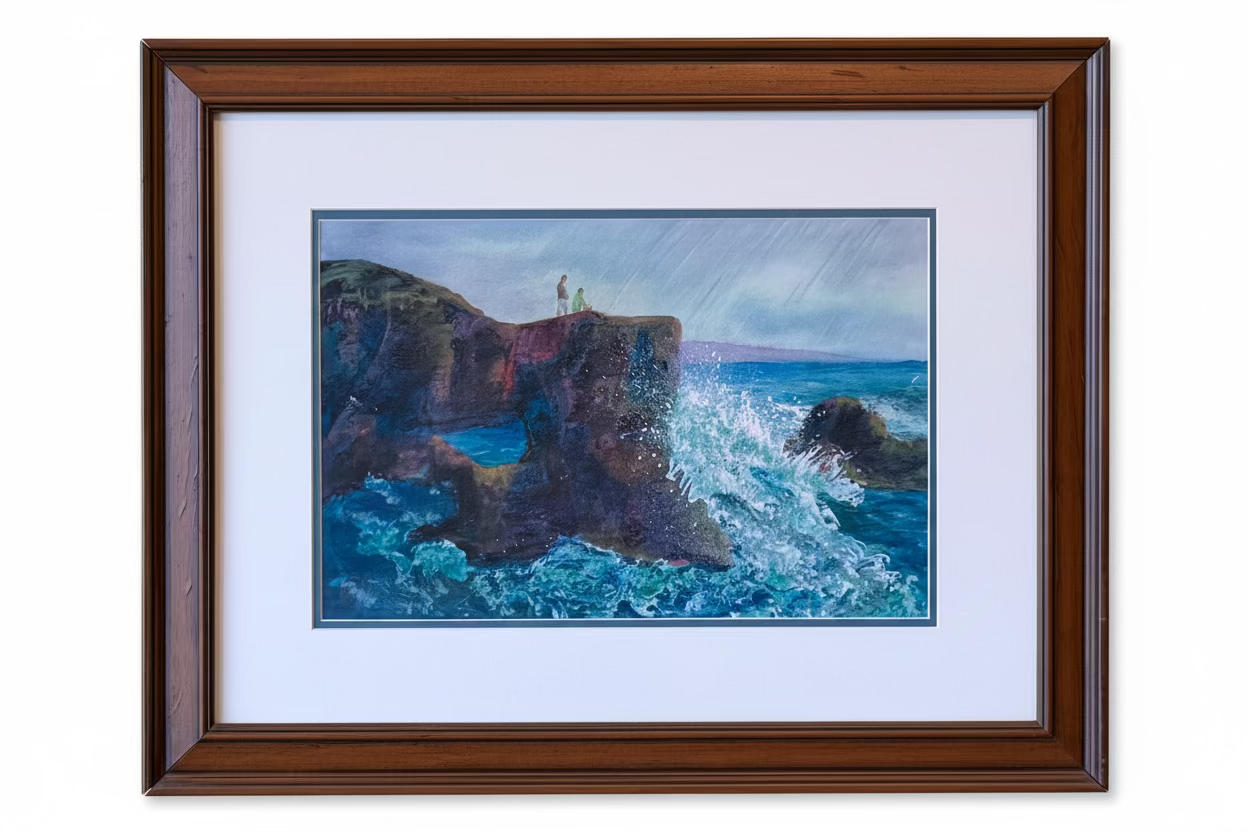 A framed coastal landscape painting featuring blue ocean waves crashing against dark rocky cliffs under a cloudy sky, presented with a white mat and a brown wooden frame on a white background. hawaii coastline 