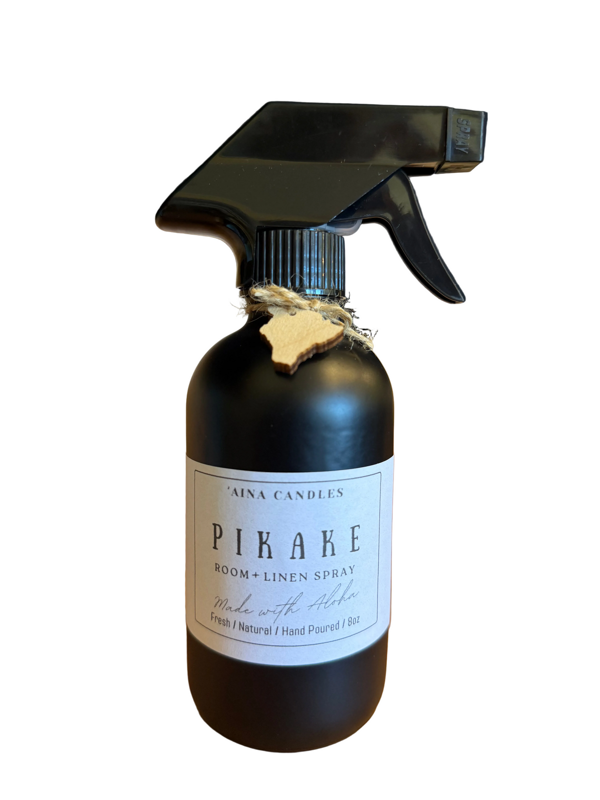 Ainá Candles Piáke Room + Linen Spray in a matte black bottle with a black trigger sprayer, a white label, and a small wooden tag tied around the neck.