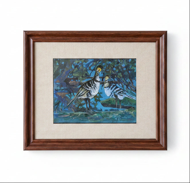 Framed artwork of a hawaiian nene goose in a natural setting on a beige wall.
