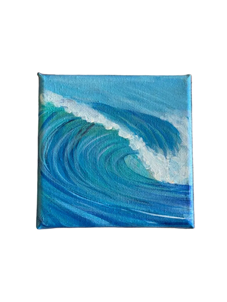 A small square canvas painting of a blue ocean wave with white foam, placed on a mango wood surface.