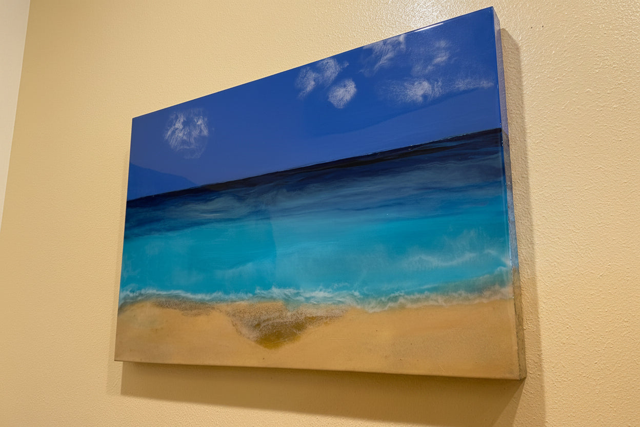 Artistic depiction of a beach scene with blue sky and ocean on a beige wall.